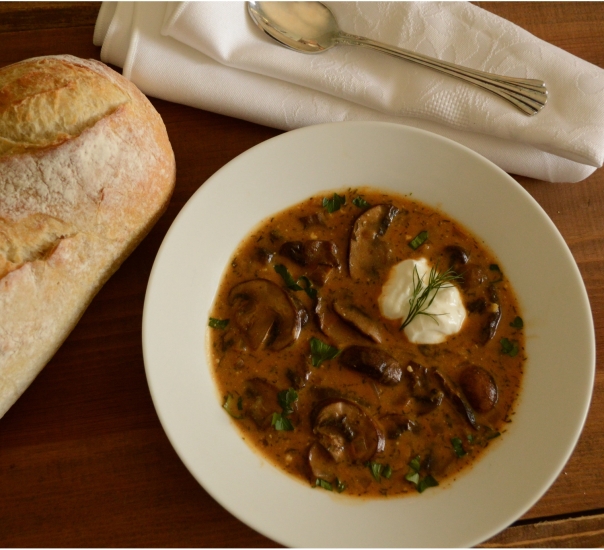 Hungarian Mushroom Soup Garnished with Sour Cream and Sprig of Dill.
